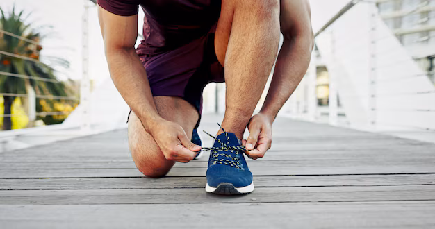 Person lacing running shoes for outdoor exercise
